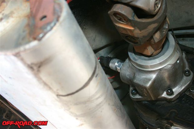Above the exhaust muffler on the rear housing of the transfer case, the speedometers sensor is installed.