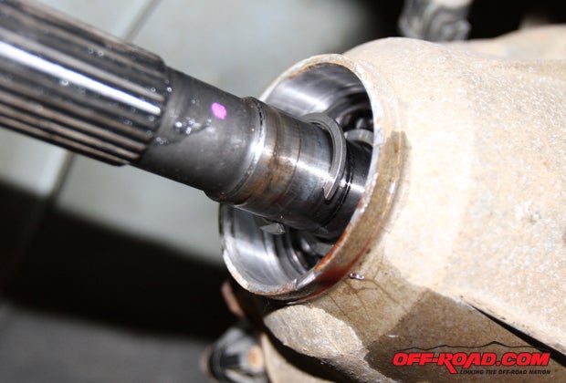 With the output shaft exposed, the C-clip on output shaft needs to be removed. Note: The larger snap ring holding the bearing in place does not need to be removed.