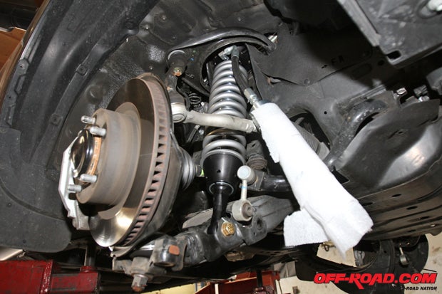 After the 2.5 Fox coilover is fitted, the lower arm is reconnected. 