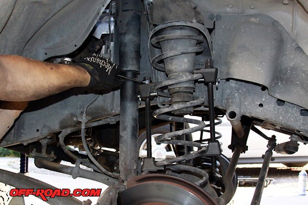 The front suspension swap is similar to the rear; only difference is that a coil compressor is used to remove the factory coil springs. You can either buy or rent a coil compressor to get the job done. Make sure the kit has two compressors, typically used on the outside of strut suspension.