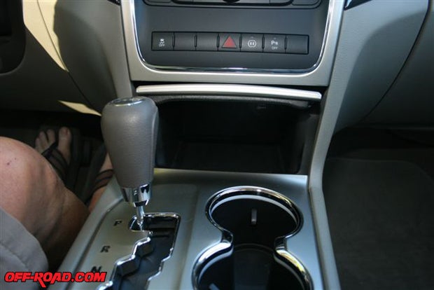 Dual cup holders and a receptacle for notebook, glasses, etc., is in the center console.