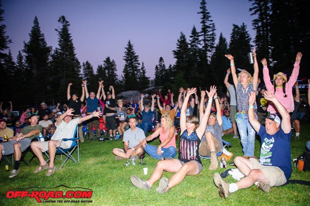 Attendees, like the crew from the Dirty Dozen, do the wave as they wait to see if they won a prize on Saturday night.