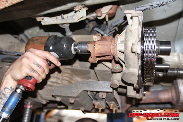 Front drive shaft yoke is removed to allow for the removal of both the front and rear output shafts next.
