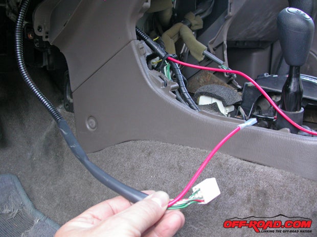 Downstream from the energizer switch, you can tuck the solitary power wire into any available loom and run it to the center console.