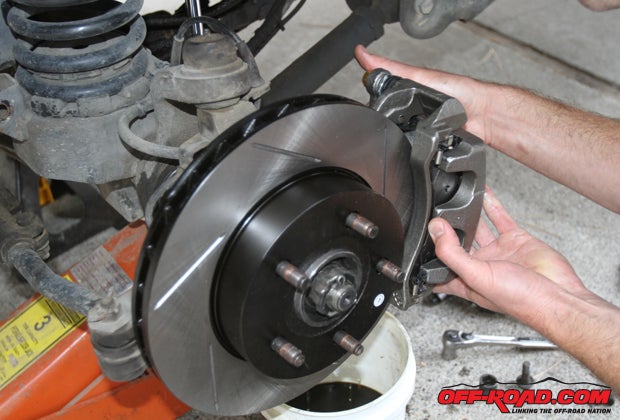 With our pads securely in place and our caliper primed, we set the new StopTech Akebono-style caliper in place.