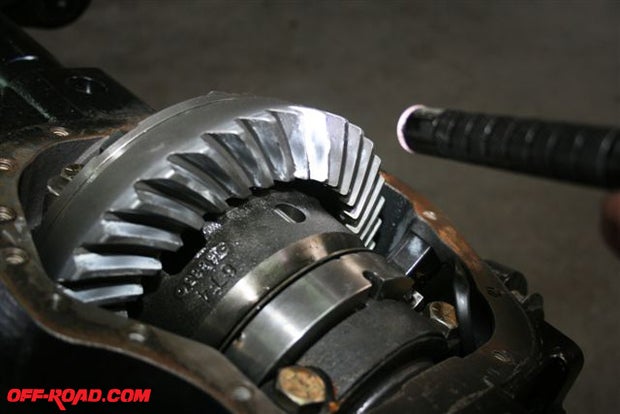 You must use a marking compound on the gears to determine if theyre set up correctly. Shims are used so that the pinion gear will contact the ring gear (shown here) in the center of the teeth.