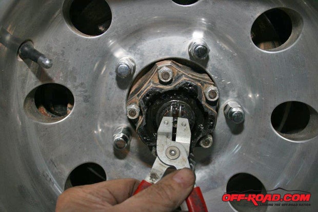 Using the snap ring pliers againand be prepared to retrieve the snap ring a few times when it flies off the axlereplace the snap ring in its groove on the axle.
