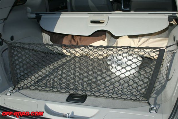 The spare tire resides below the carpeted hatch and the cargo net protects your groceries. The panel above the net can be deployed to cover the storage area for protection against prying eyes.