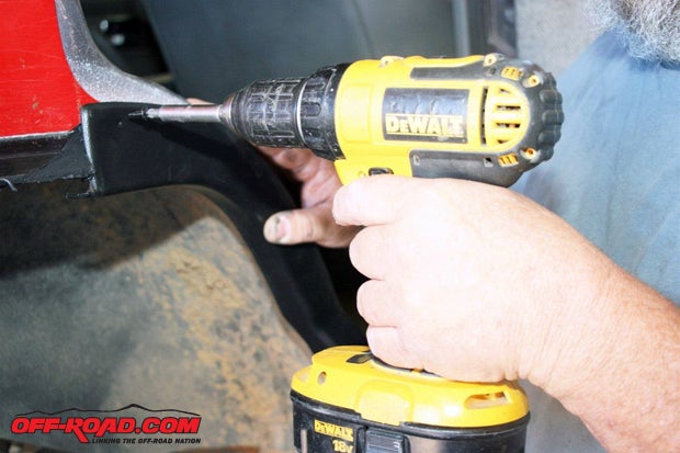 At the rear door opening, secure the dog-leg shaped trim against the body with the supplied self-tapping screws.