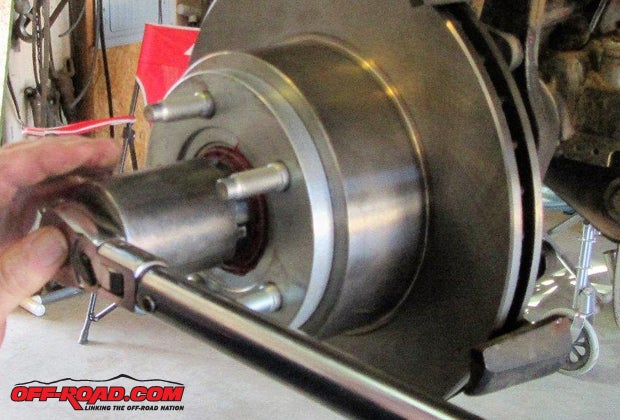 Use the proper spindle nut socket and torque the inner locking nut to 50-ft.-lb. After torqueing the nut, rotate the rotor in both directions to assist in seating the bearings, then loosen the nut a quarter-turn to release some pressure on the bearings.