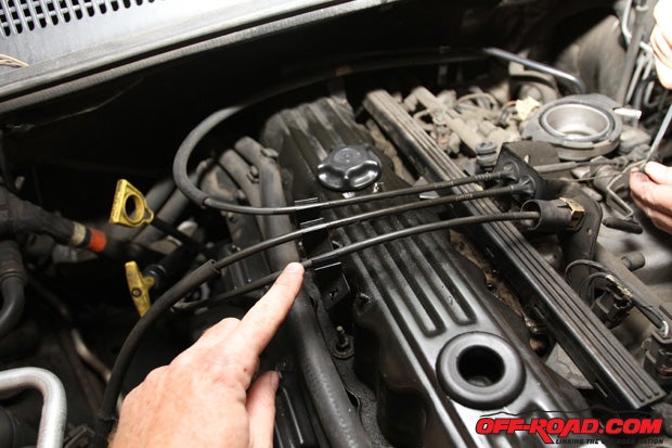 Youll need to remove the throttle and cruise control cable crossing the valve cover, which is held in place with a bracket on the left-hand side of the motor. 