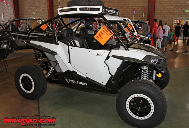 Burts UTV featured a few unique custom builds at the show, with one being this pre-runner style 2014 Polaris RZR XP 1000. This vehicle features TSR Twisted Stitch custom seats, a 20-inch LED light bar, a custom roll case with aluminum top, Method wheels, pre-runner style roof rack and dome light.
