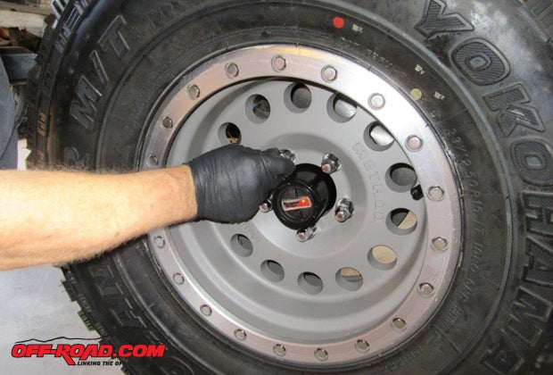Install the brake pads in the calipers and then install the calipers. Slip the hub lock onto the spindle, then install the wheels, they hold the hub lock in place. Torque the lug nuts to Jeeps specifications.