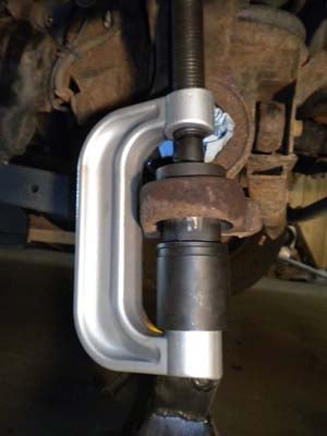 Smear some grease on the joint and around the hole before you start pressing the new ball joint in. You’ll get a workout putting the bottom one in.