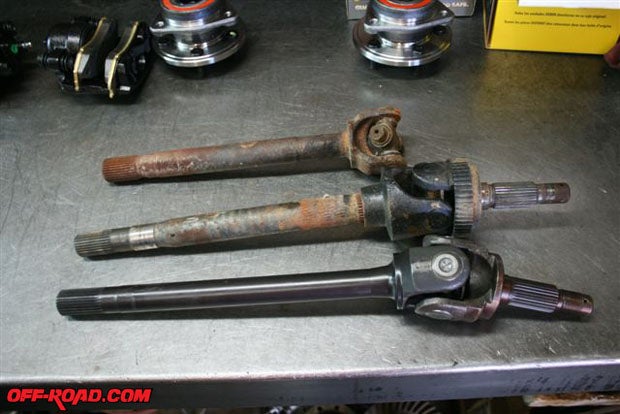 Now we move up to the front of the Cherokee. Here are two examples of the OEM Dana 30 axles and the new G2 axle.