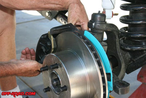 Follow a Jeep shop manuals instructions and attach the new caliper.