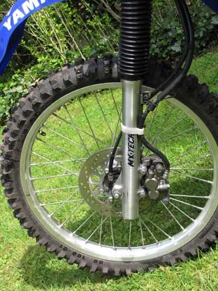 With the forks stiffened by the addition of .46mm/Kg straight-rate fork springs, we now had a more controlled, though still spindly, front end. 