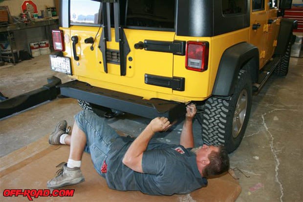 Remove the OEM bumper and save the bolts to use later with Ranchos bumper. Temporarily attach the Rancho bumper using the original hardware.