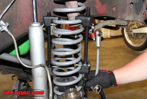 We install the coil spring compressor tool to remove the spring from the stock spring mounts. 
