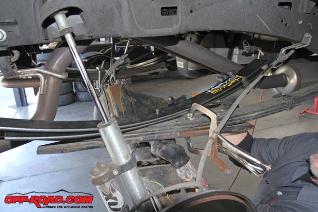 The Hellwig leaf springs can now be installed on top of the factory leaf pack, with the long side forward. Using the included new, longer center bolt, install the new Hellwig springs and torque down the center bolt.