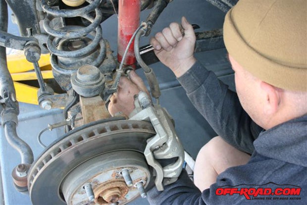 Remove both OE shock absorbers and set the nuts and bolts aside.