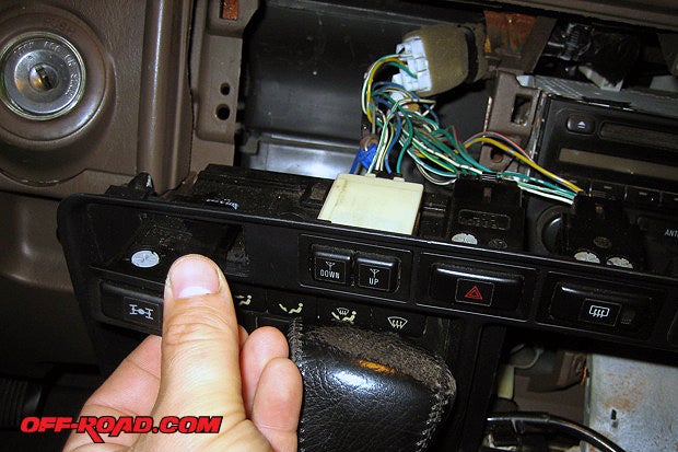Remove one of the blank switch templates and insert the switch by pushing into the hole.