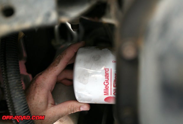 The location of your oil filter will vary depending upon the vehicle, but once you locate it see if it can be removed by hand. If its very tight, this is where the oil filter tool will come in handy. As you remove it, be mindful that a small amount of oil may still spill out. If you notice in the photo, not using gloves means dirty hands, so a set of gloves will make cleanup easier. If not, some heavy-duty hand cleaner like Fast Orange will help. 