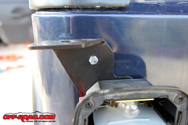 The bolt goes through to the inside of the Jeep cab and attaches via a locknut, providing additional security for the antenna mount.