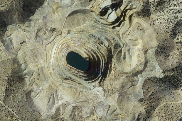 Satellite Image shows the large scale open pit mine workings of the Colosseum Mine (Image Google Maps/USGS).