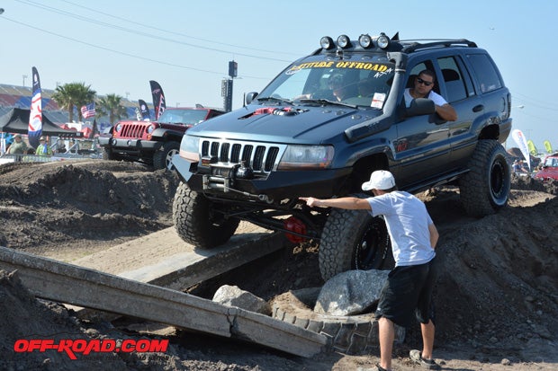 Spotters help this WJ through a tricky part of the obstacle course.