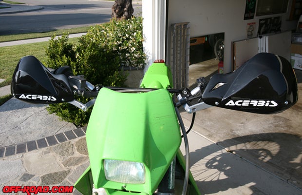 With the hand guard frame fully installed, the last step is to attach the plastic hang guard covers. Acerbis includes both small and large plate covers, so install whichever suits your type of riding or personal preference.