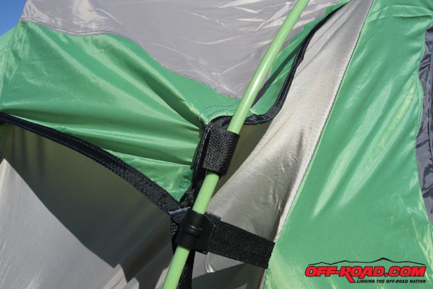 To help secure the rain fly, Velcro straps (top) hold it in place on the tent poles, while the tent poles themselves have nice guide holders (bottom) sewn into the tent to keep them in place.