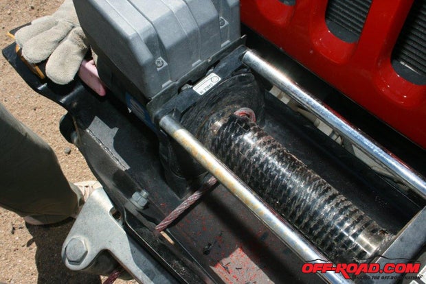 Superwinch uses a combination Allen screw and a hook on the end of the cable to secure the OEM cable to the capstan. Both ends of the cable are painted red to warn the user when the cable is getting close to its end.