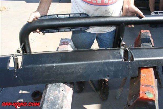 There are slots cut in the Slider Steps (where the bungee cord is coming out) that match with the welded-in slider plates that serve to locate the steps while they are being deployed or held in the traveling position. The slider plates also anchor the bungee cord.