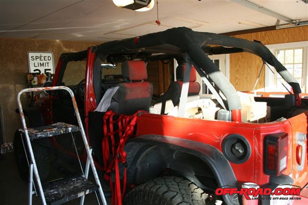 Youll need a ladder or step stool if your Jeep is lifted. Lay each cargo net out and straighten its straps before starting attachment.