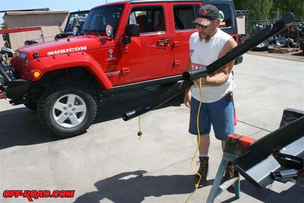 Be very careful when assembling the Slider Step to the rocker panel protector, if the bungee cord should slip and retract into the step, youll have to use heavy twine or a light rope to fish it through as demonstrated here by club member Gordy Both. Gordy volunteered to help me install the Slider Steps at Precision Automotive in Kingman, AZ.