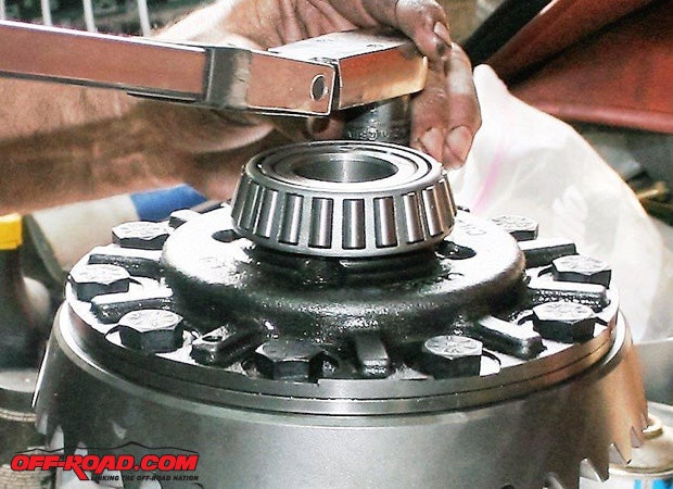 The carrier, ring, pinion, side gears, and bearings must be assembled properly. The carrier must be torqued to the ring gear according to the manufacturer’s specification.