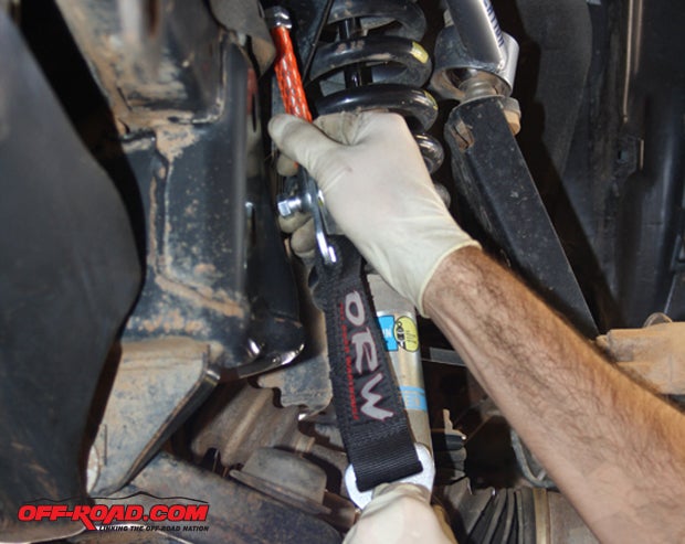 Mounted inboard of the brake/hub/wheel of an independent-suspension assembly means this strap will be short, and its action will involve of the straps innate stretch. It also means you can get away with less strap.