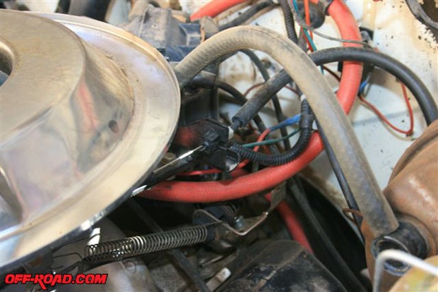 Buried in the spaghetti of cables, wires, and hoses is the oil pressure sender.