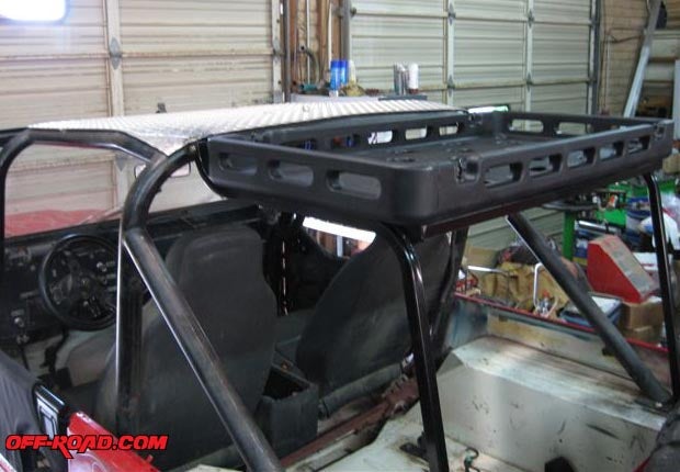 With the rack tray mounted, its top is level with the top of the rollbar, so the Jeep will still fit in our garage.