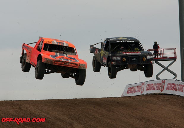 Adrian Cenni (11, left) passed early race leader Kyle LeDuc but later lost the lead after rolling his truck in a turn. 