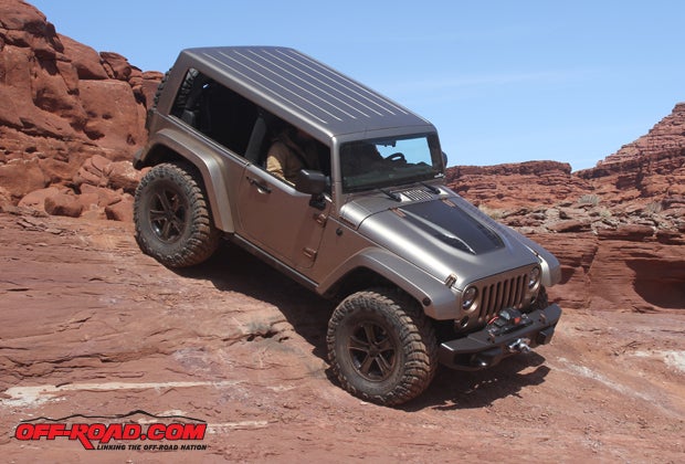 The Flattop is a chop-top two-door JK where the roof line is lowered and windshield are lowered 2 inches. Although the stock suspension is retained, with a low center of gravity and some one-off fender flares specifically designed for the vehicle, the Jeep design team was able to fit 37-inch Mickey Thompson rubber on the Flattop