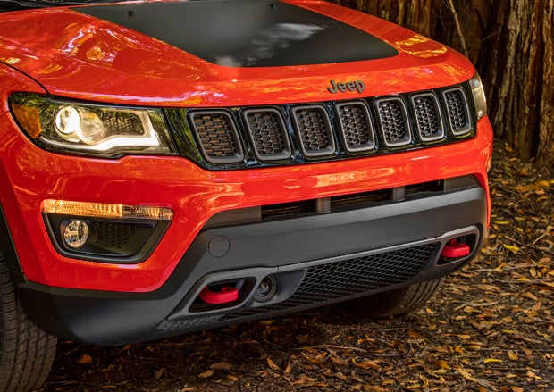 The Compass Trailhawk features Jeep's signature red towhooks up front.
