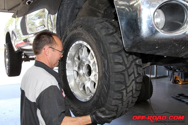 Once our 35-inch R/Ts were mounted on our 18-inch Black Rhino wheels, Gary gets the tires mounted up to the truck. Although theyre not light, the R/T isnt as heavy as we expected weighing in at 77 pounds. 