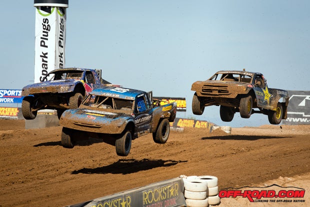 Pro 4 trucks battle it out over the jump. 