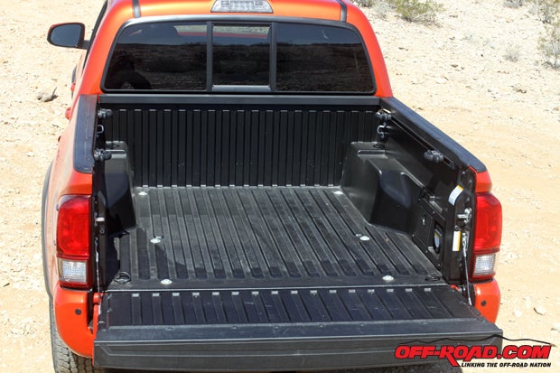 The composite truck bed of the Tacoma features both a 120-volt outlet and four adjustable tie-down cleats.