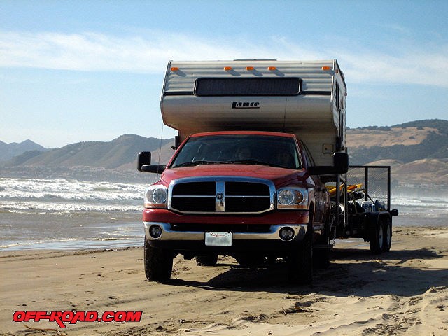 Towing on the beach is an adventure in itself. 4WD is recommended as is airing down to 15psi. If you time it right, low-tide will give you more hard-packed sand to drive on.