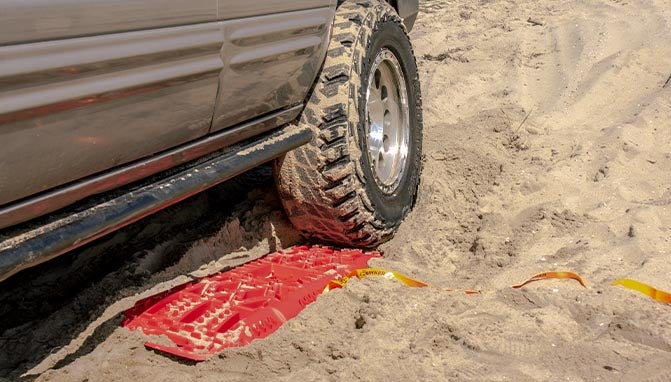 bunker industries traction board in front of tire in sand