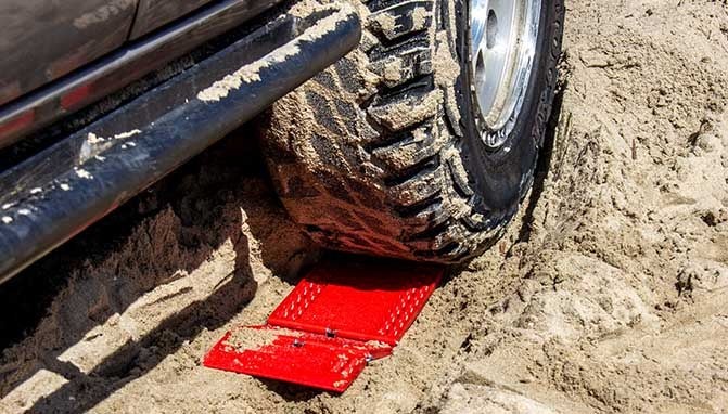 dedc traction mats static in sand in front of stuck tire