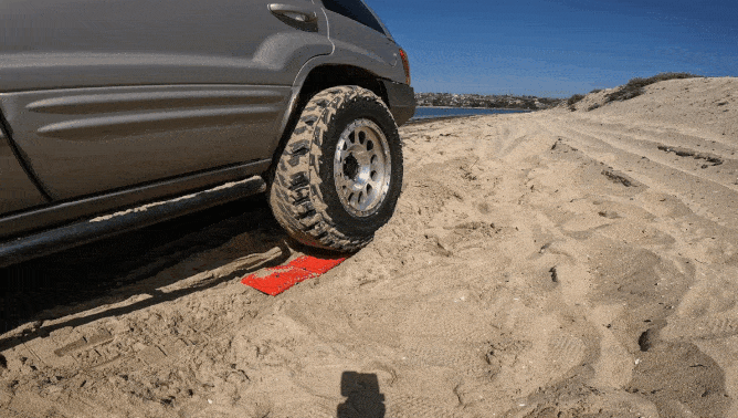 dedc traction mat in action in beach sand with jeep